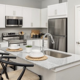 kitchen with ample counter-space, modern appliances and bright lighting