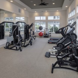 fitness center with open spaces and bright lighting through the windows